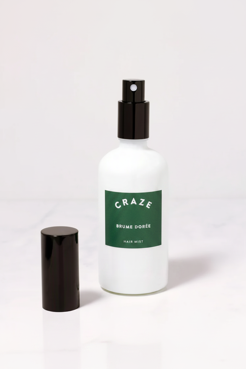CRAZE Brume Dorée Hair Mist spray bottle uncapped with black cap beside it