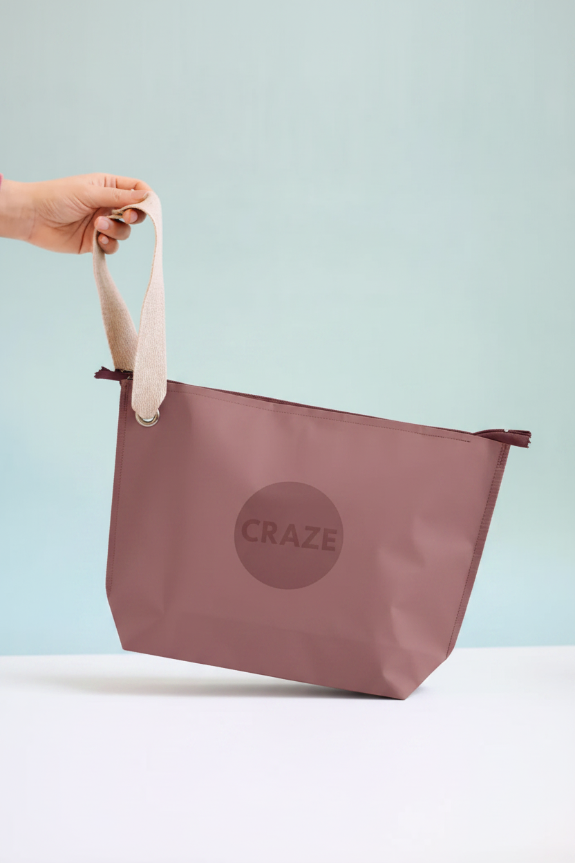 CRAZE Dusk Travel Pouch held by hand against soft teal background